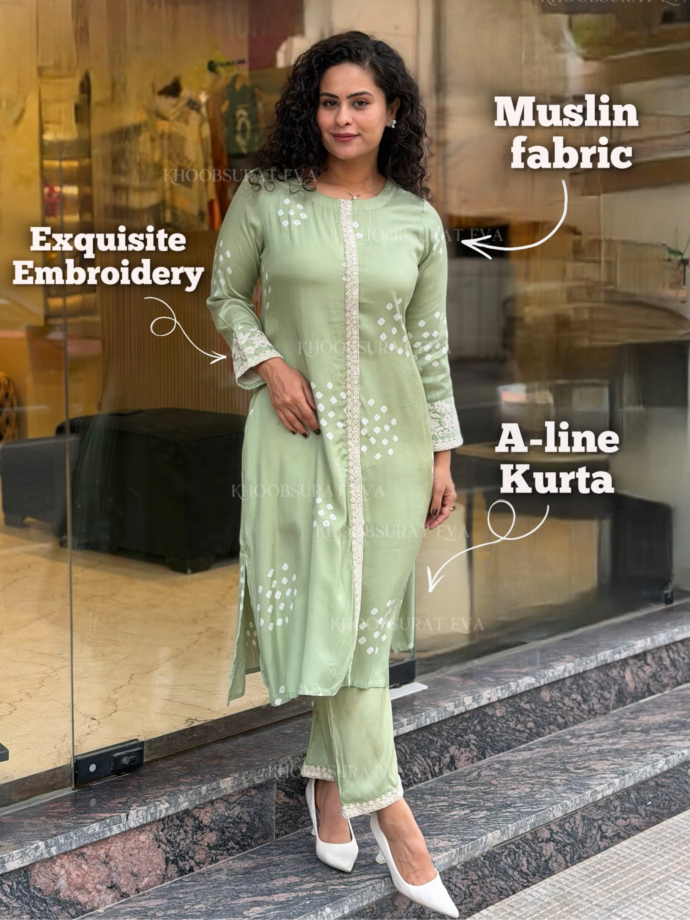 Woman wearing a light green A-line kurta with embroidery, standing in front of a glass door.