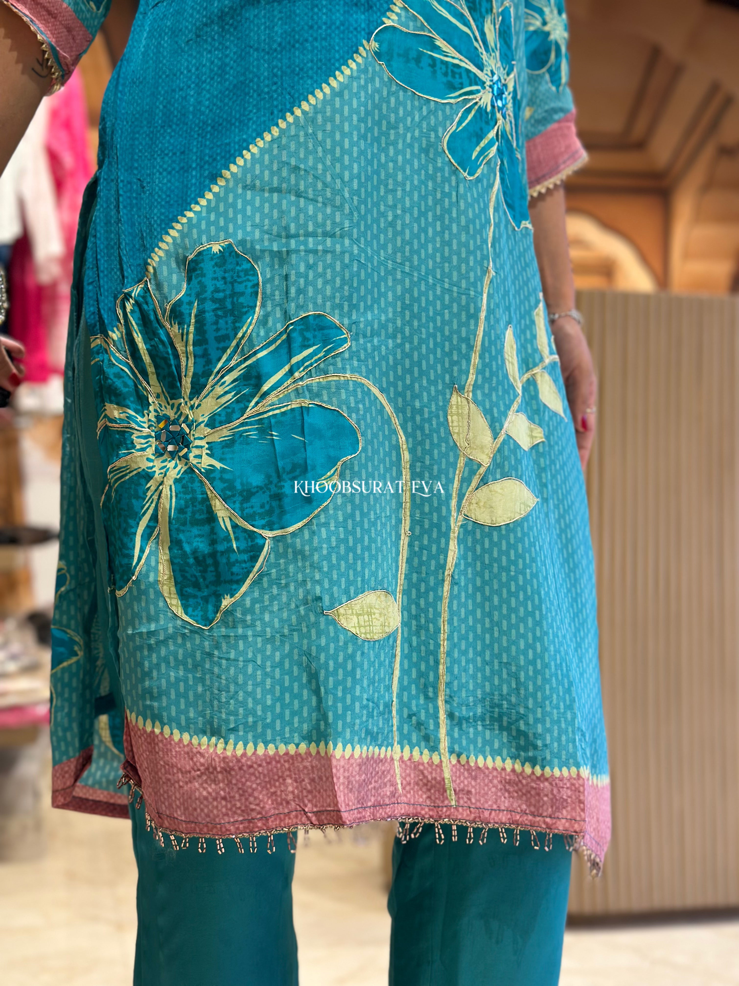 Teal embroidered suit set with pink border 